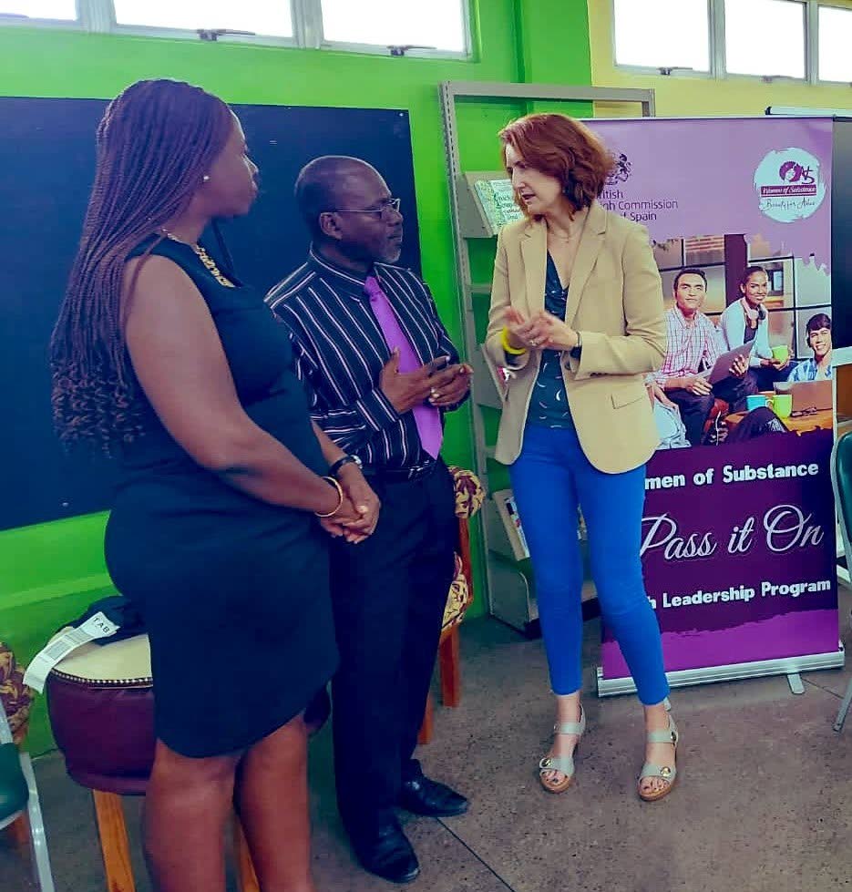 British High Commissioner Harriett Cross, right, chats with Woman of Substance founder Onika Mars, left, and an official at Signal Hill Secondary on Monday. Photo source: Harriett Cross' Twitter page