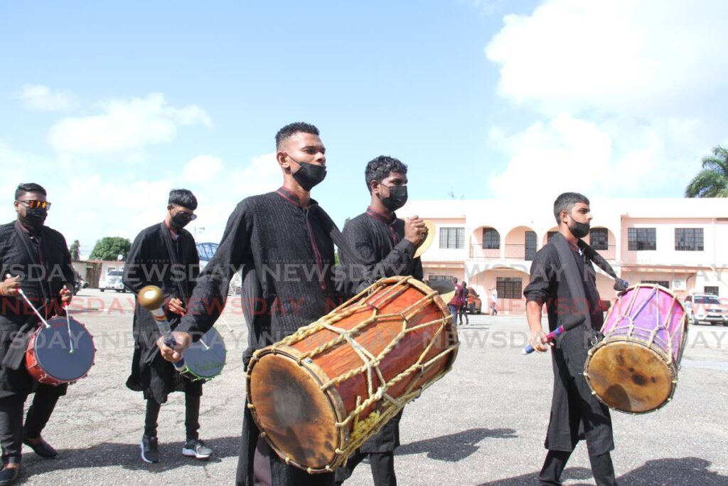 DRUMS FOR ANIL: Drummers herald the arrival of Indo/Crossover artiste Anil Bheem's body for his funeral on Thursday at the National Council for Indian Culture (Divali Nagar) site in Chaguanas on Thursday.