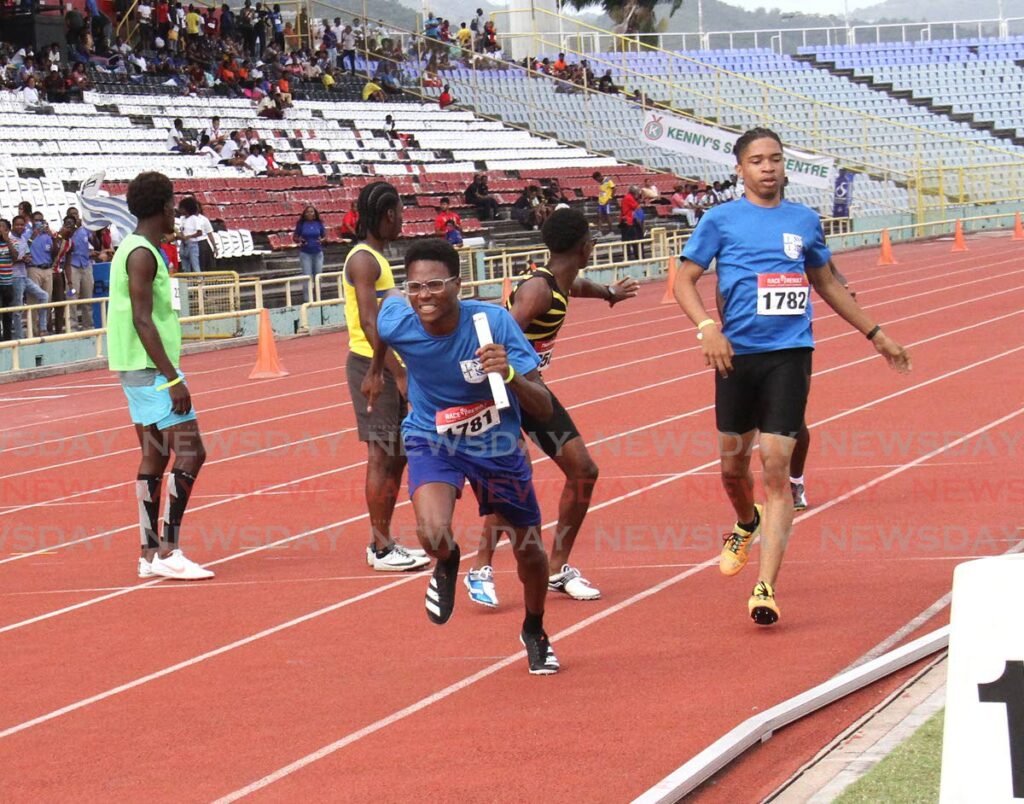 WATCH ME SPRINT: St Francis Boy's College's Stefan Camejo kicks off after receiving the baton in the Boys 17 and Over 4x100 relays at the Secondary Schools track and field relay festival on Thursday at the Hasely Crawford Stadium in Mucurapo.