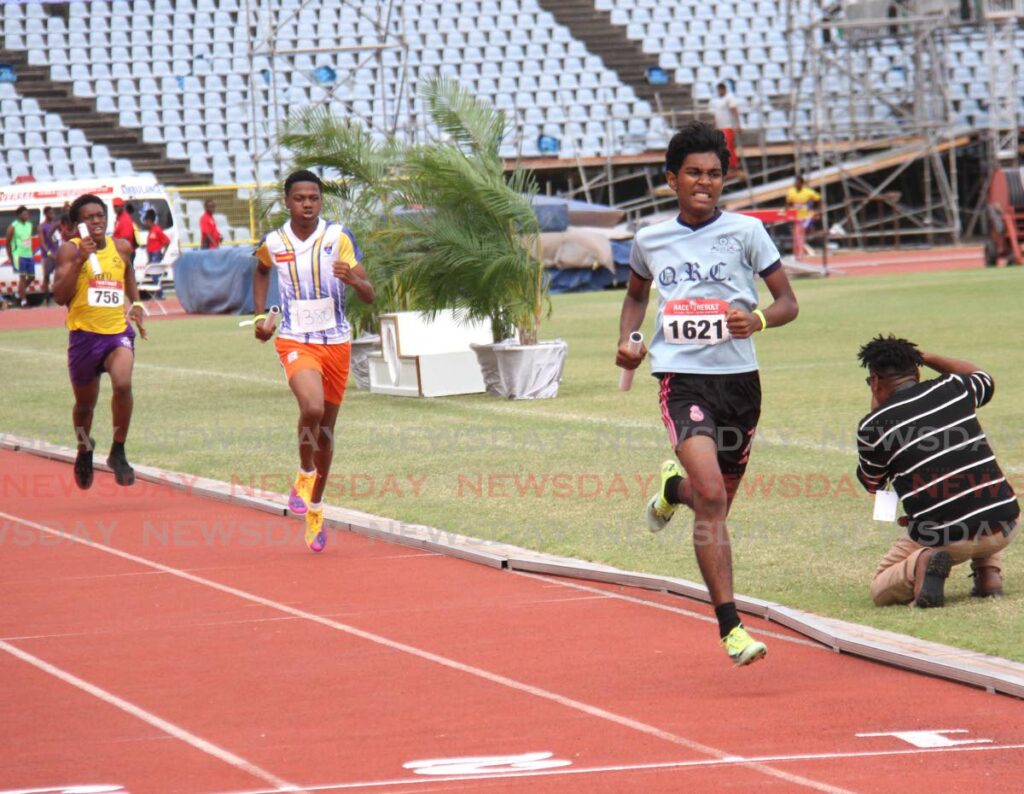 Queen's Royal College's Luke Williams wins the boys U-17 4x400m relay. - Photo by Ayanna Kinsale
