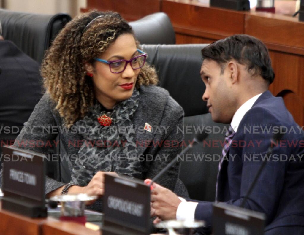St Augustine MP Khadijah Ameen and Princes Town MP Barry Padarath in discussion during a sitting of the House of Representatives on Friday. - Angelo Marcelle
