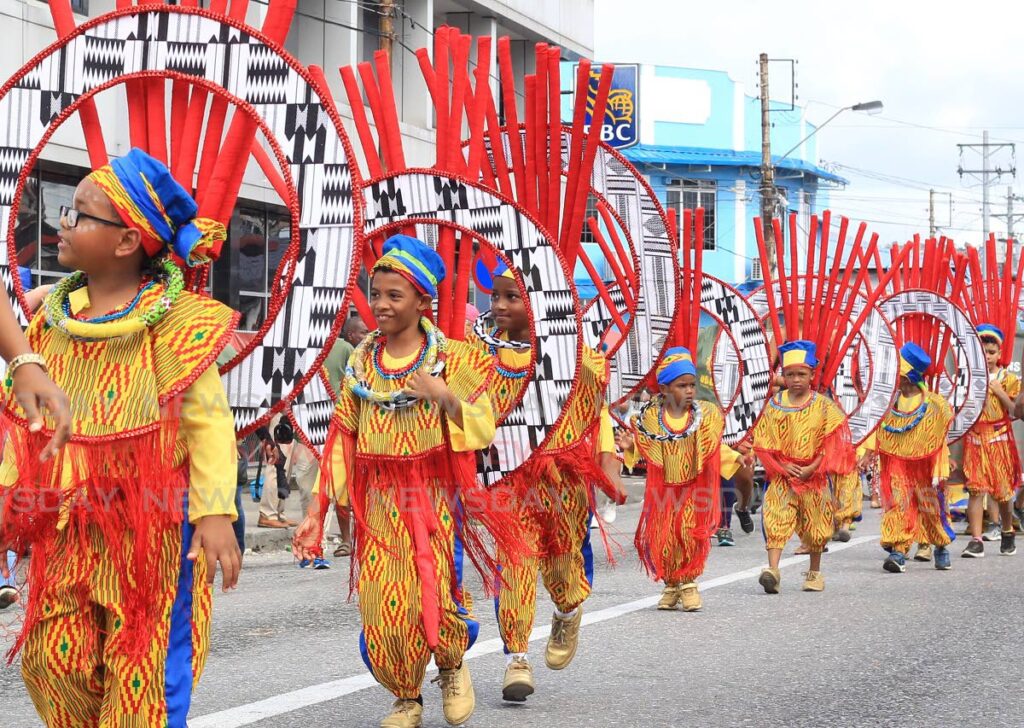 Masqueraders in Spoilt Rotten Kids's UNIKE band parade along the Western Main Road at the St James Children's Carnival on Sunday.  - ROGER JACOB