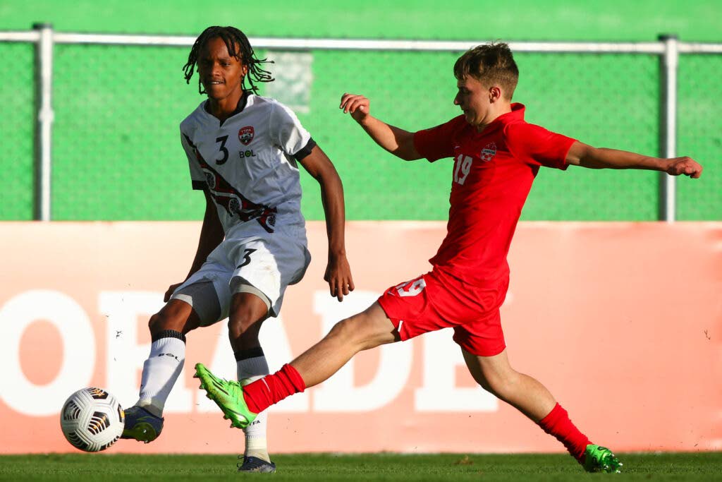 Joshua Figaro of TT, left, competes for the ball with Kyler Vojvodic of Canada during the Group F match between the teams in the CONCACAF Men's Under-17 Championship, held at the Pensativo stadium, in Antigua City, Guatemala. - 