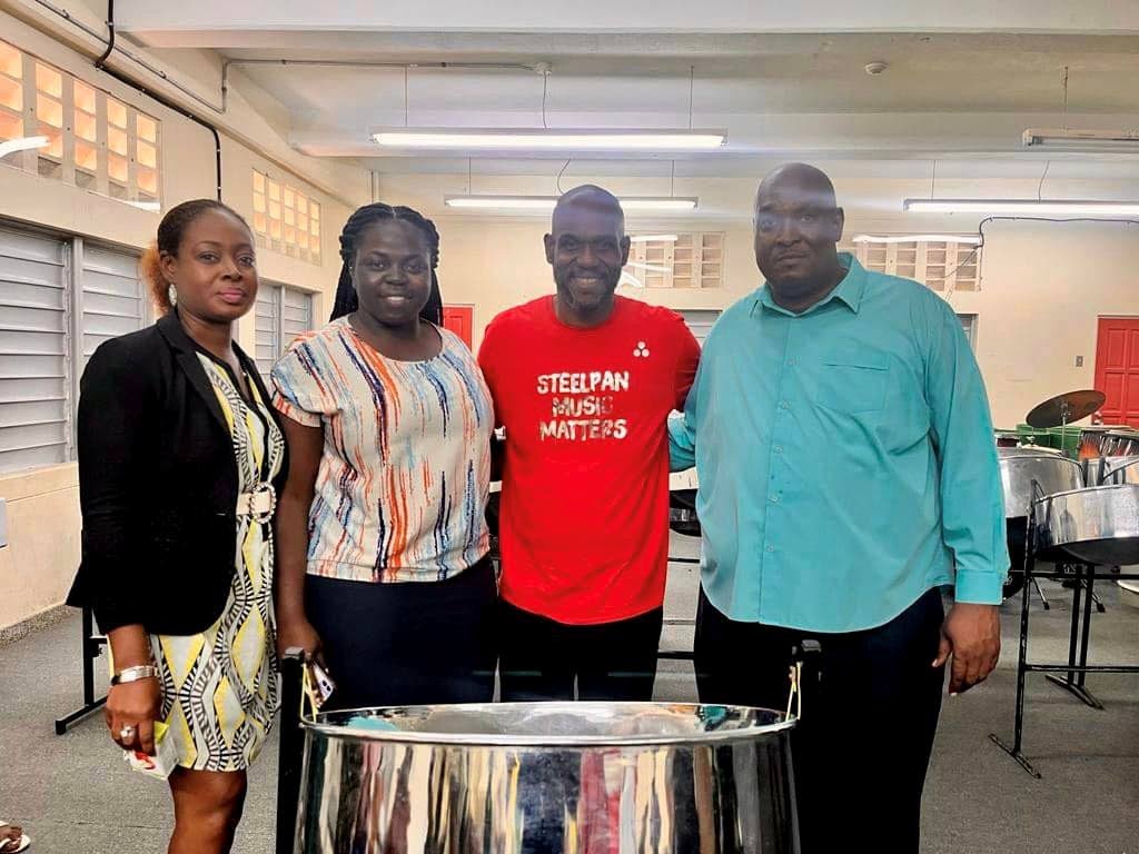 Arranger Duvone Stewart, second from right, with school officials at Signal Hill Secondary on Monday. Photos courtesy Signal Hill Secondary.