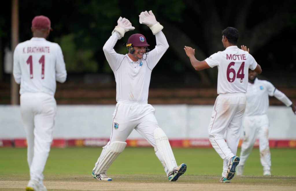 West Indies spinner Gudakesh Motie, right, celebrates a wicket with wicketkeeper Joshua Da Silva on day 3 of the 2nd Test at Queens Sports Club in Bulawayo, Zimbabwe, Tuesday. (AP Photo)