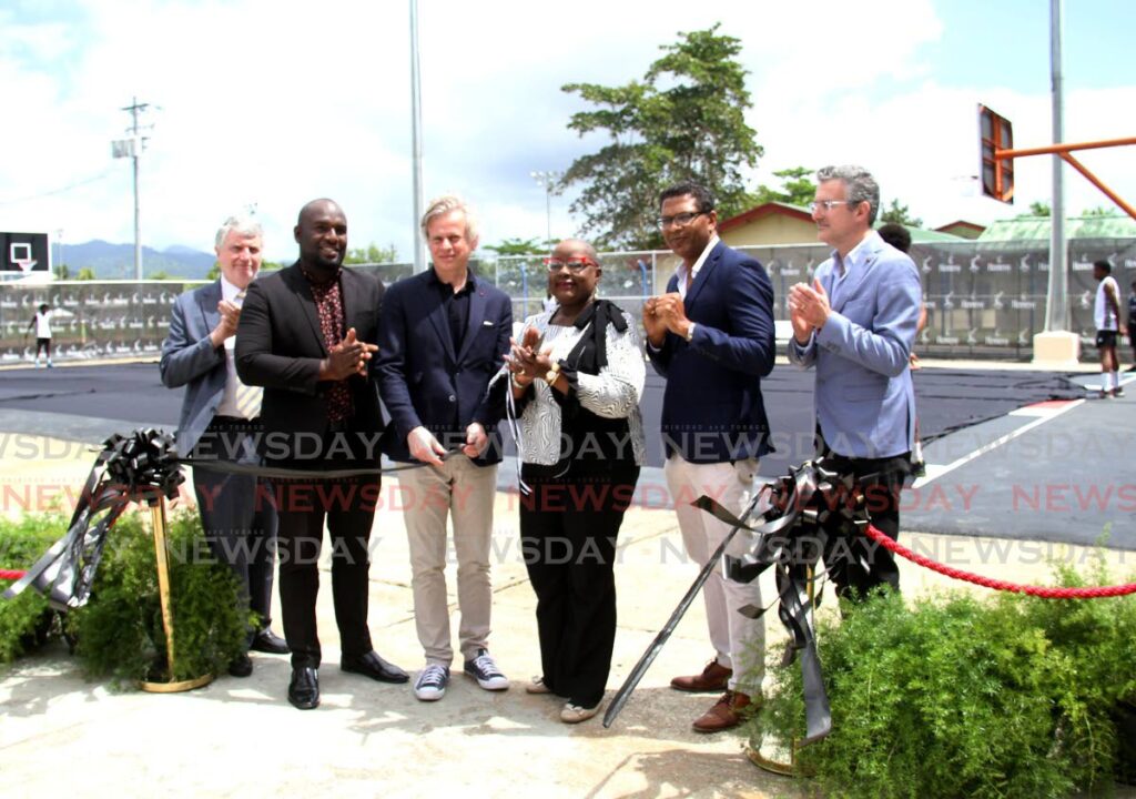 From left,  French Ambssador Didier Chabert, Mausica/Maloney Councillor Stephan Wattley, Hennessy CEO Laurent Boillet, Minister of Housing and Urban Development Camille Robinson Regis, AS Bryden and Sons Group CEO Richard Pandohie, and International Director Hennessy Eric Gilbert cut the ribbon during the Hennessy/NBA unveiling of the refurished Maloney basketball court, Maloney, on Wednesday.  - AYANNA KINSALE