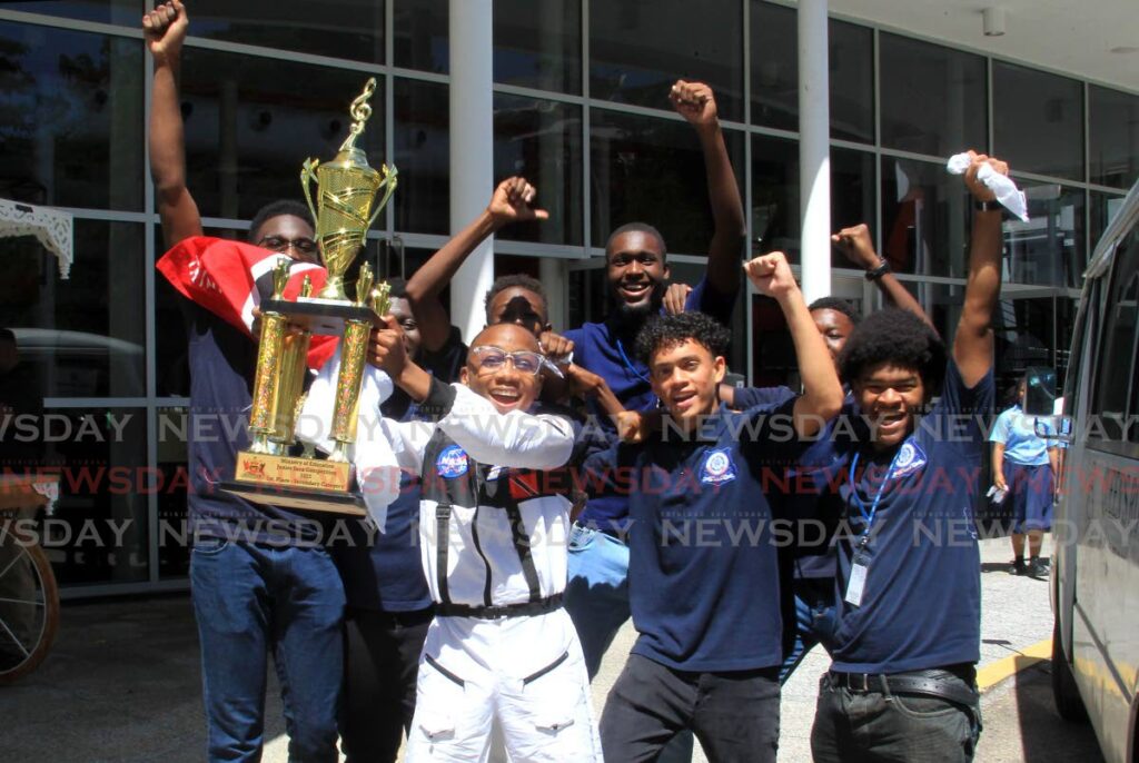Sekel Mc Intosh of Queen's Royal College celebrates with his friends after winning the secondary schools category in the  Ministry of Education  Junior Soca Competition at Queen's Hall, Port of Spain, on Thursday. - AYANNA KINSALE