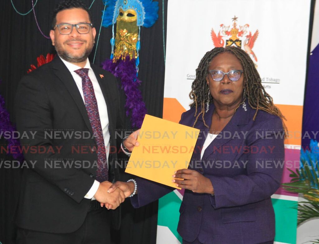 Minister of Tourism, Culture and the Arts Randall Mitchell presents Pan Trinbago president Beverly Ramsey-Moore with a grant during the distribution ceremony at the VIP Lounge, Queen's Park Savannah, Port of Spain, on Thursday. - AYANNA KINSALE