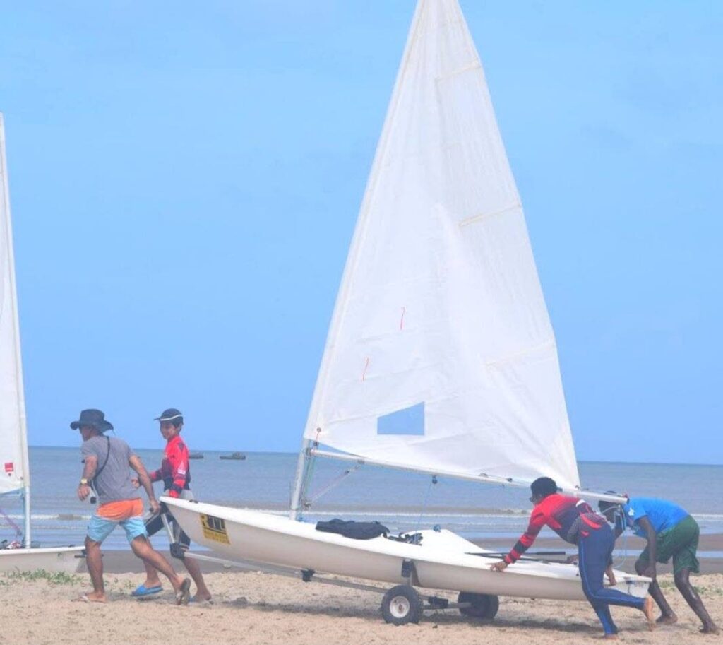 Sailors, along with a coach, get prepared to compete in series one of the National Dinghy Championships 2023 at Vessigny Beach earlier this month. - 
