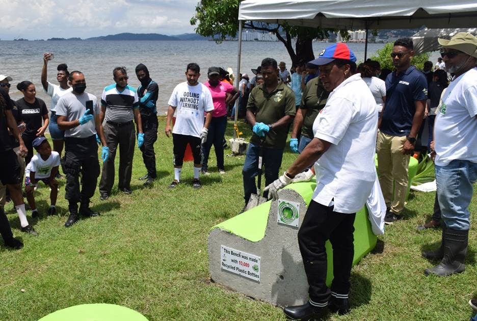 Planning and Development Minister Pennelope Beckles, third from right, presents a bench made from 10,000 plastic bottles at the Mucurapo foreshore in Port of Spain after a recent coastal clean-up activity.
 
