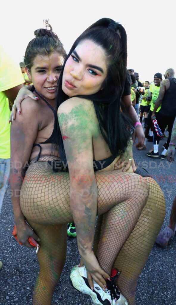 Two friends from the band Jumbeez J'Ouvert play themselves at the Maraval Parkway near the Hasely Crawford Stadium on Monday morning. PHOTO BY ROGER JACOB - 