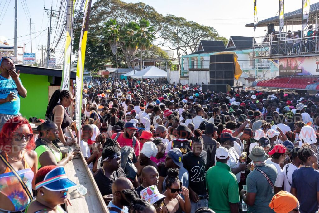 Revellers enjoy J'Ouvert in Crown Point on Monday. 
