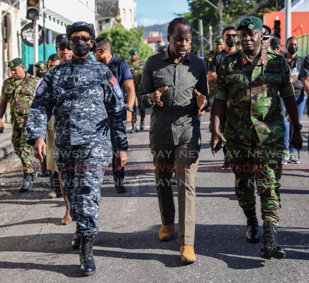 Commissioner of Police Erla Harewood-Christopher, left, Minister of National Security Fitzgerald Hinds, centre, and acting Chief of Defence Staff Brigadier Dexter Francis during walkabout on Abercromby Street, Port of Spain on Carnival Tuesday. - JEFF K. MAYERS