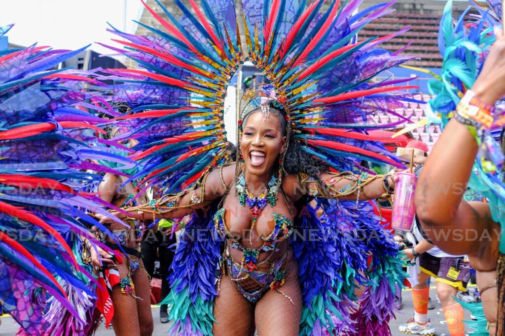 A masquerader from Tribe presentation New Dawn crosses the Socadrome stage on Carnival Tuesday.  - JORDON BRIGGS