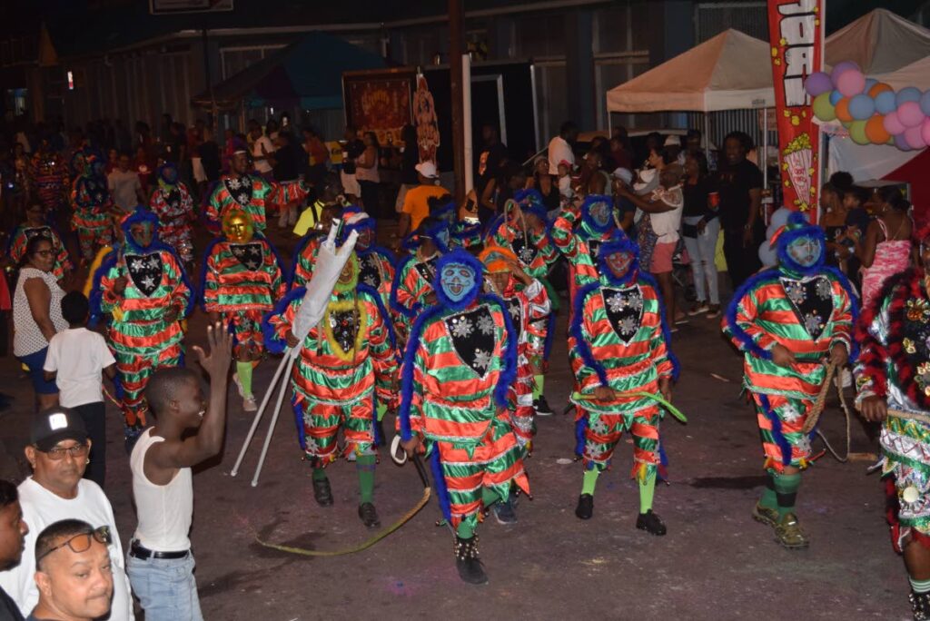 Masqueraders from First Citizens Orginal Jab Jab presentation of Festival of the Ancestors by Ronald  Alfred make their way to the stage. - 