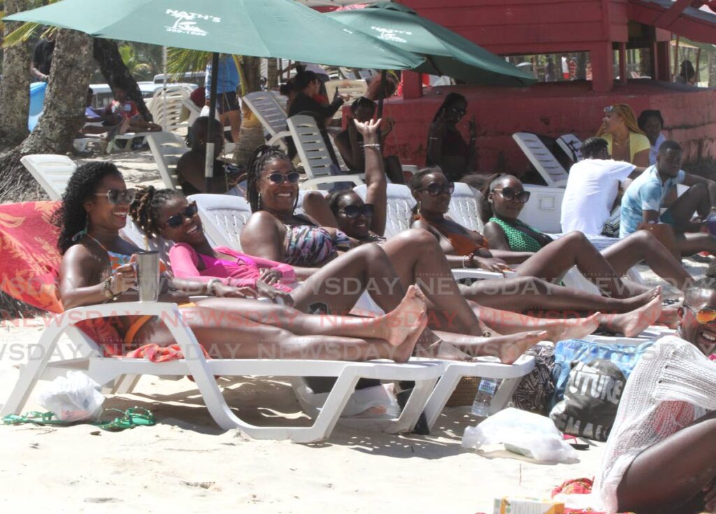 Visitors from the England sun bathe at Maracas Bay on Ash Wednesday. Photo by Angelo Marcelle