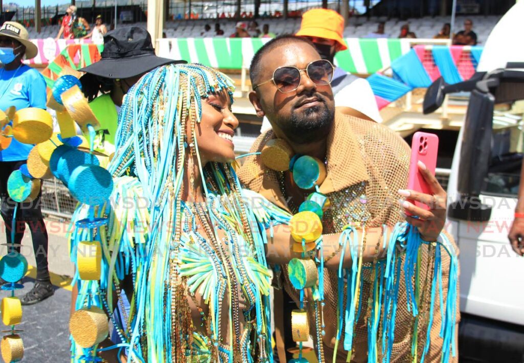 A maquerader takes a selfie with creative director and bandleader of Lost Tribe Valmiki Maharaj on Carnival Tuesday at the Queen's Park Savannah, Port of Spain. Photo by Ayanna Kinsale