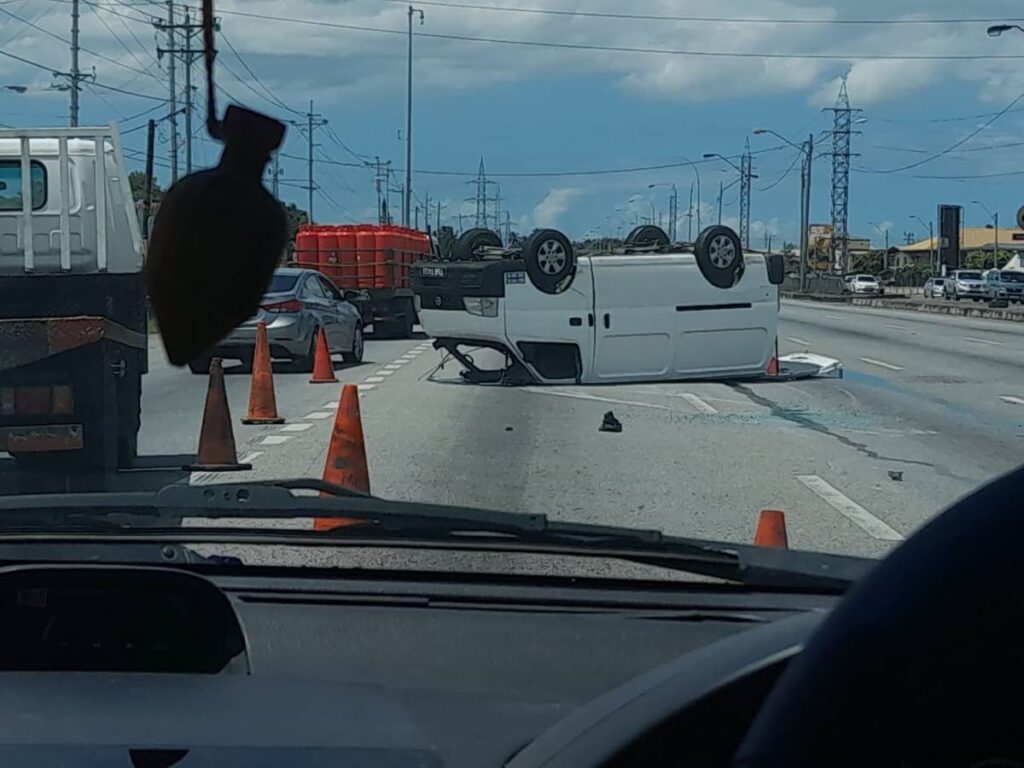 A van which landed on its roof during an accident near Aranguez on Saturday along the Churchill Roosevelt Highway.  Photo courtesy Tarikkh Hackshaw