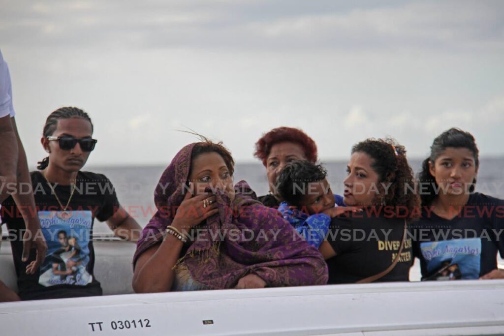 An emotional Venessa Kussie, widow of Rishi Nagassar, and the families of Fyzal Kurban, Kazim Ali Jr and Yusuf Henry out at sea for a memorial for four divers who died in a Paria pipeline in 2022,  on Saturday evening. Photo by Marvin Hamilton