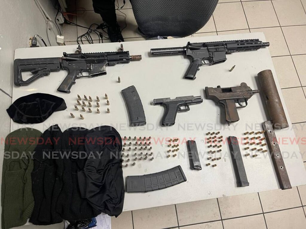 Guns, ammunition and ski-masks seized during an anticrime operation in Tunapuna on February 22. - 