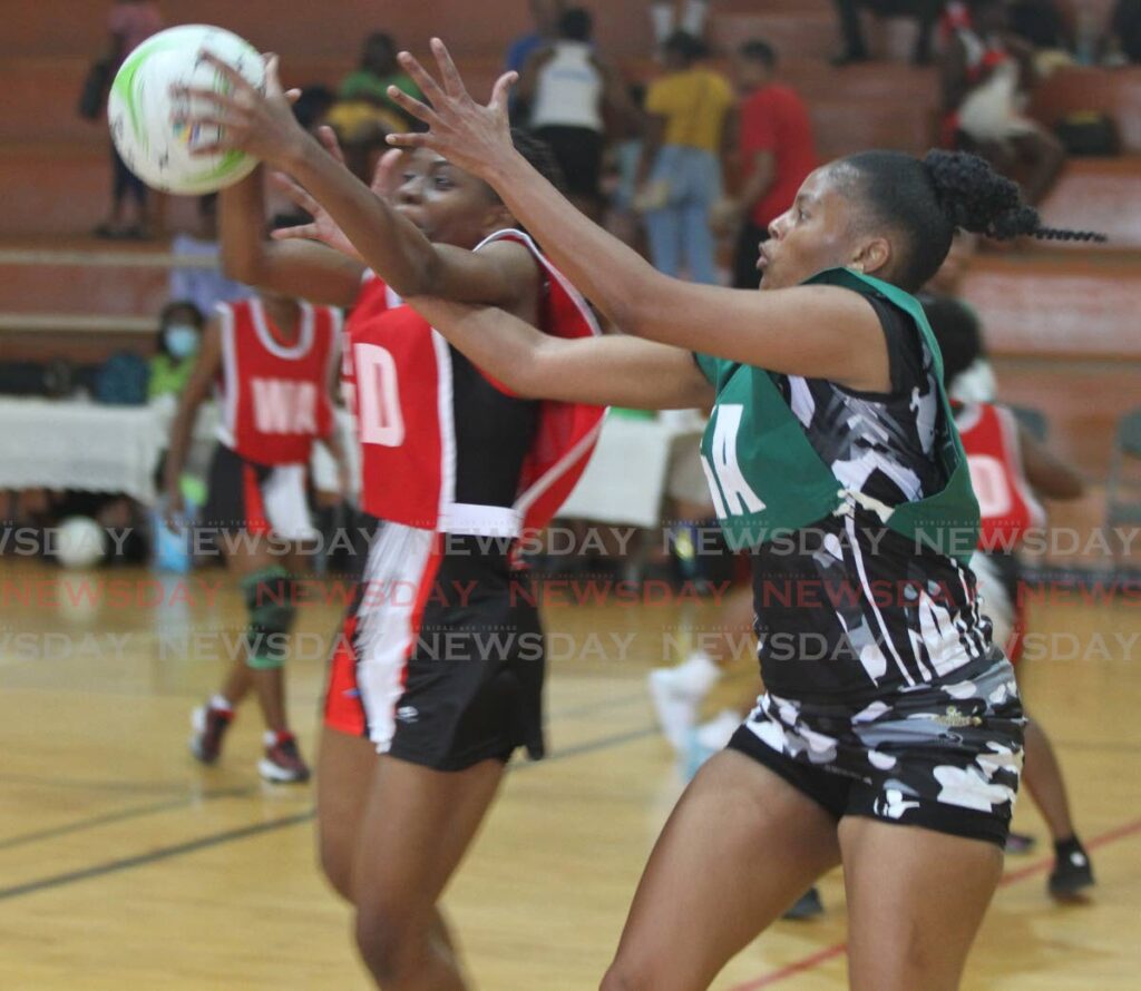 A Fire player, left, catches the ball under pressure from a Defence Force opponent. FILE PHOTO 