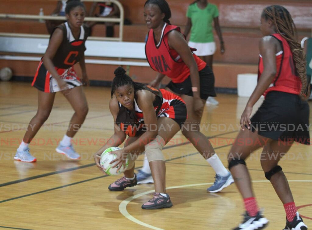 A UTT player protects the ball from her Fire opponents, in the Courts All Sectors Netball League, at the Eastern Regional Indoor Facility, Tacarigua. FILE PHOTO/ANGELO MARCELLE - 