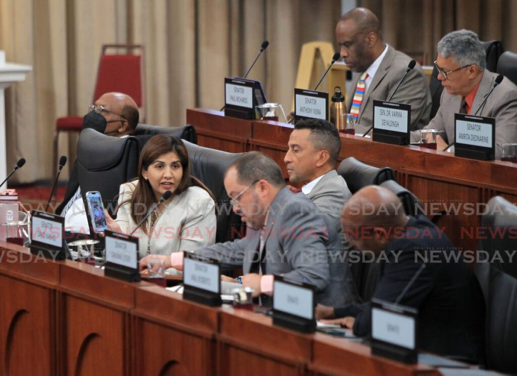 From left, Opposition senators Jayanti Lutchmedial, David Nakhid, and Damian Lyder converse during the sitting of the Senate, Red House, Abercromby Street, Port of Spain, on Tuesday. - AYANNA KINSALE