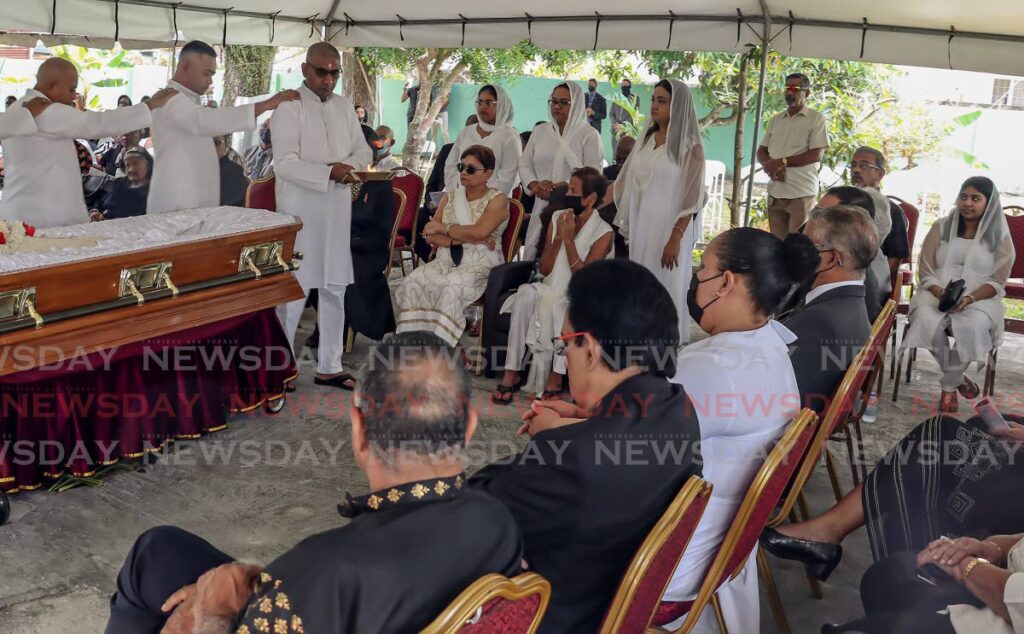 Members of Jarette Narines family perform his funeral according to Hindu rites at his home on Church Street, Samaroo Village, Arimam, on Thursday. - Roger Jacob