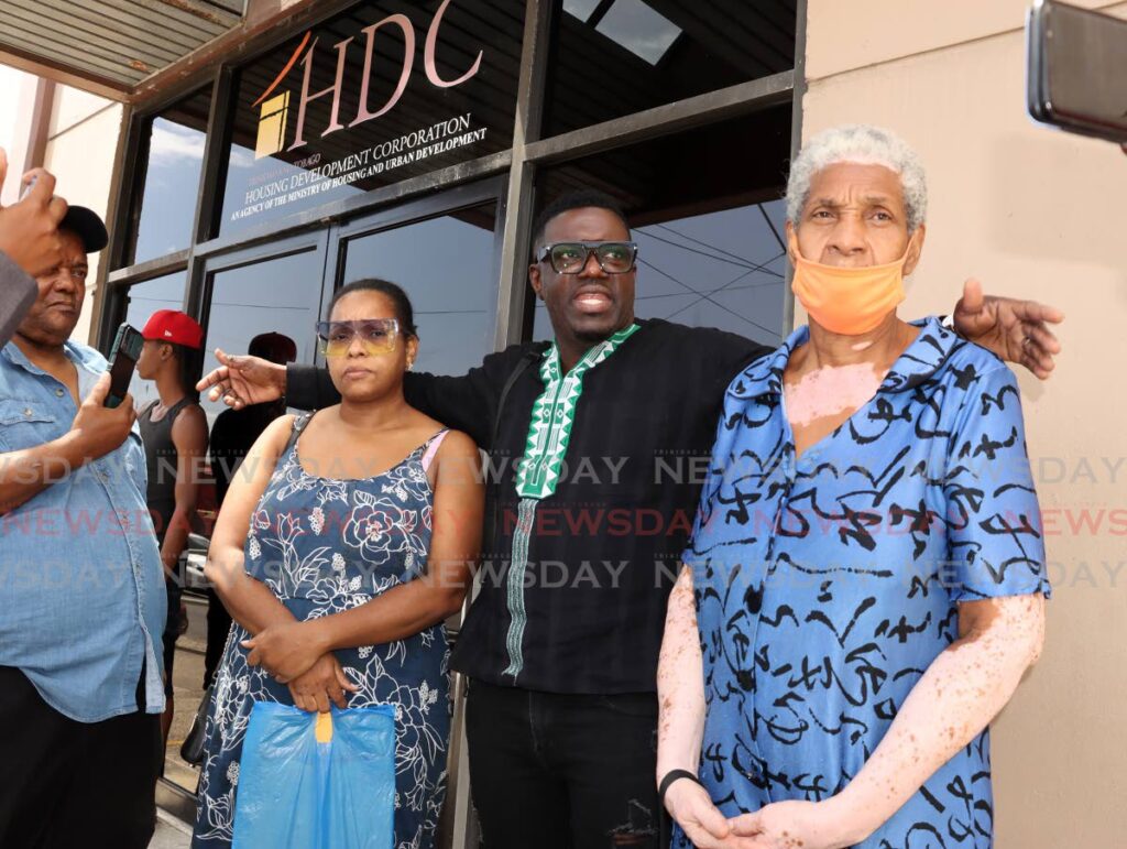 PDP political leader Watson Duke, second from right, speaks to media with East Port of Spain residents Neisha Mendoza, second from left, and Colleen Mendoza before staging a sit-in protest at HDC's offices on South Quay, on Friday. - Photo by Roger Jacob