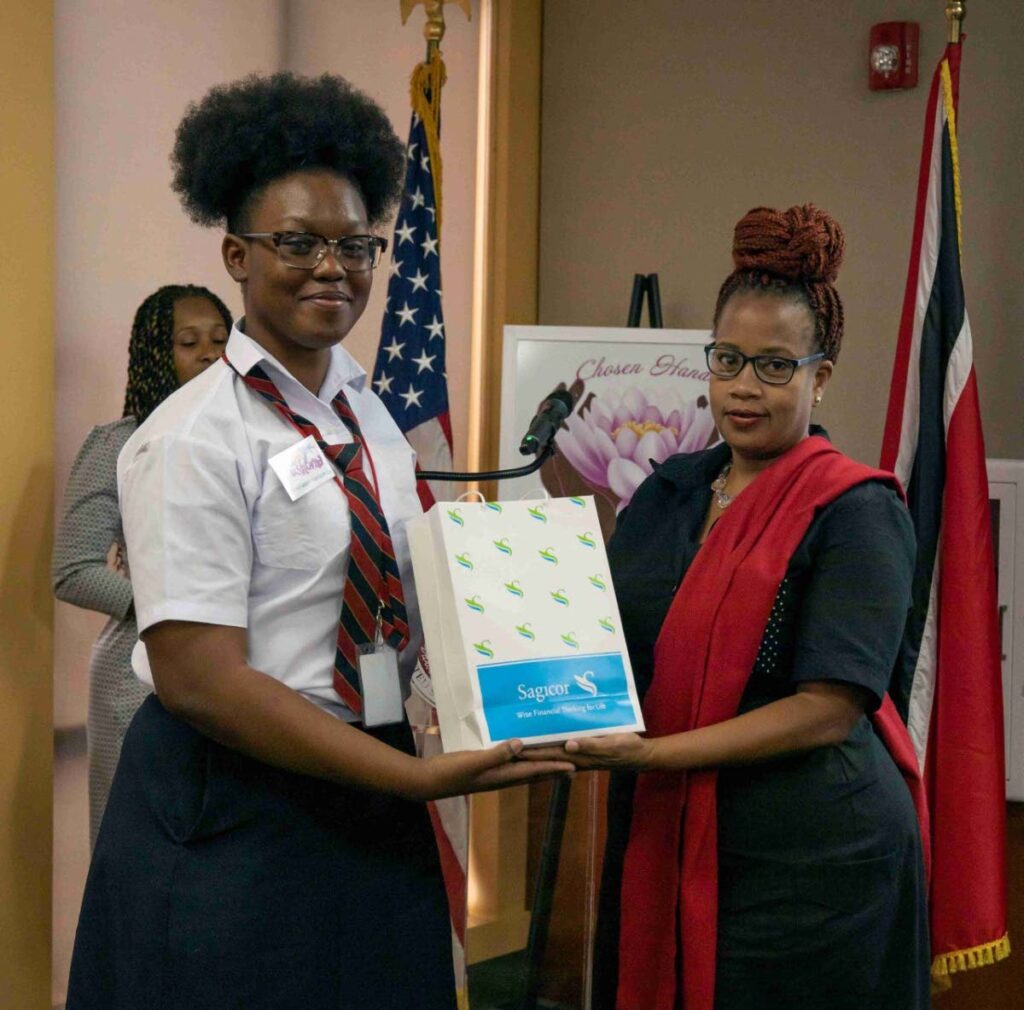  Anika Plowden-Corentin, right, the founder of the Chosen Hands programme, presents Bishop Anstey East student Trishorna Delancey with a Sagicor gift at the NGO’s promoting social change through the arts workshop. - 