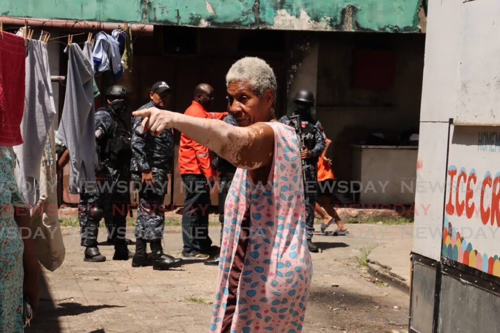 East Port of Spain resident Colleen Mendoza gestures as HDC tenants were forced Saturday to evacuate an apartment complex on Duke Street. - Photo by Roger Jacob