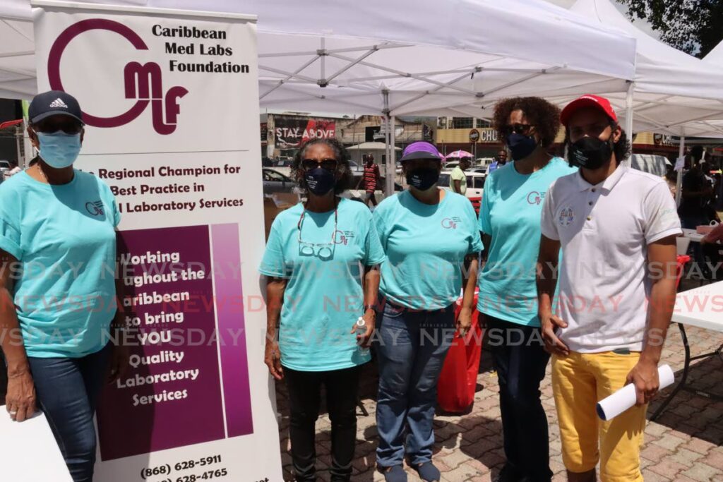 In this file photo, some of the volunteers who offered free covid19 testing and medical counselling on the Brian Lara Promenade on March 3. The outreach was organised by PAHO in collaboration with Catholic Commission for Social Justice, Caribbean Med Labs Foundation and Medical Research Foundation. - ROGER JACOB