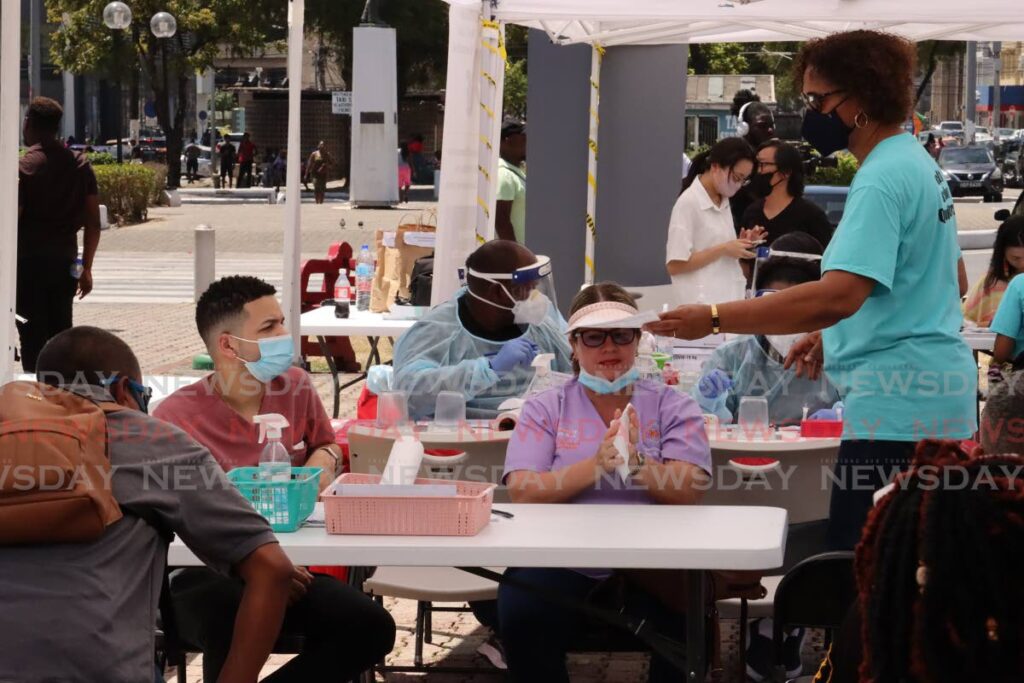 People take advantage of free covid testing on the Brian Lara Promenade, Port of Spain on Saturday organised by PAHO in collaboration with Catholic Commission for Social Justice, Caribbean Med Labs Foundation and Medical Research Foundation. - ROGER JACOB
