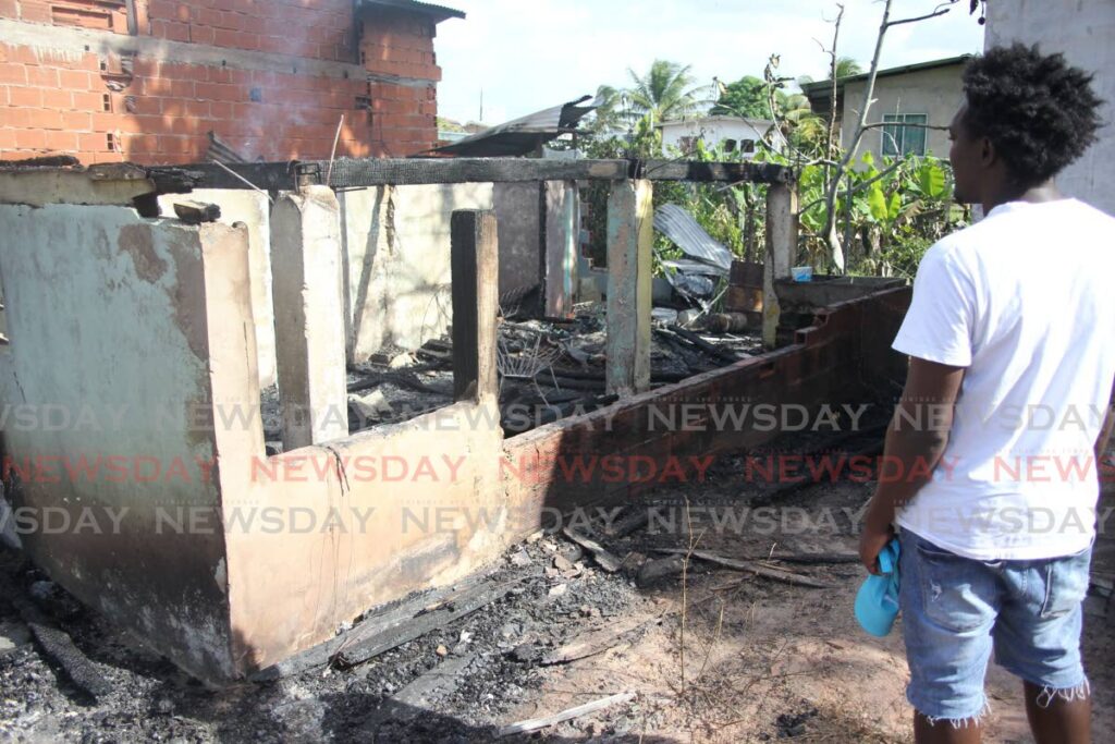 Nigel Jones looks at the ruins of his apartment at Maharaj Street, Gasparillo on Saturday.  - Lincoln Holder