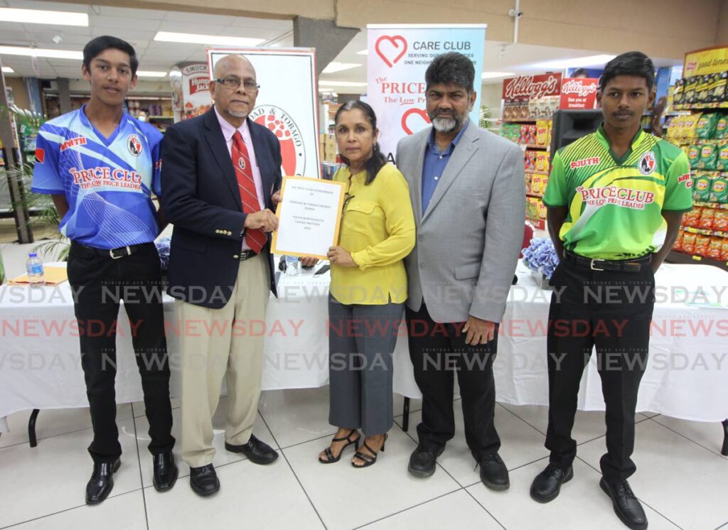 TT Cricket Board president Azim Bassarath, second from left, receives an enveloped cheque from Price Club Supermarket directors Sheliza and Shamshad Ali at a handing over ceremony, Price Club, Chaguanas on Monday. On left is North Under-15 captain Yasir Deen and on right is South captain Brendon Boodoo.
 - Angelo Marcelle