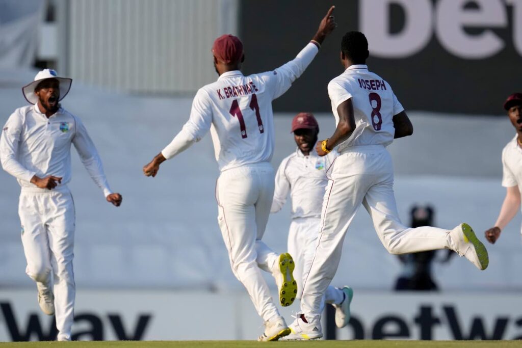 West Indies's bowler Alzarri Joseph (R) runs as he celebrates with teammates after dismissing South Africa's captain Temba Bavuma for a duck during the second day of the first Test, at Centurion Park in Pretoria, South Africa, on Wednesday. - AP