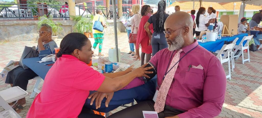 Assistant Secretary of Health, Wellness and Social Protection Sonny Craig gets his blood pressure checked in Scarborough on Wednesday. - 