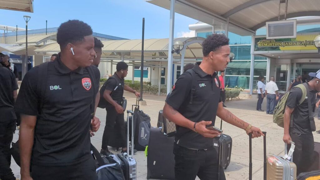 TT footballers Joevin Jones, left, and his brother Alvin, right, arrive in Jamaica for two international friendlies along with the rest of the squad. - 