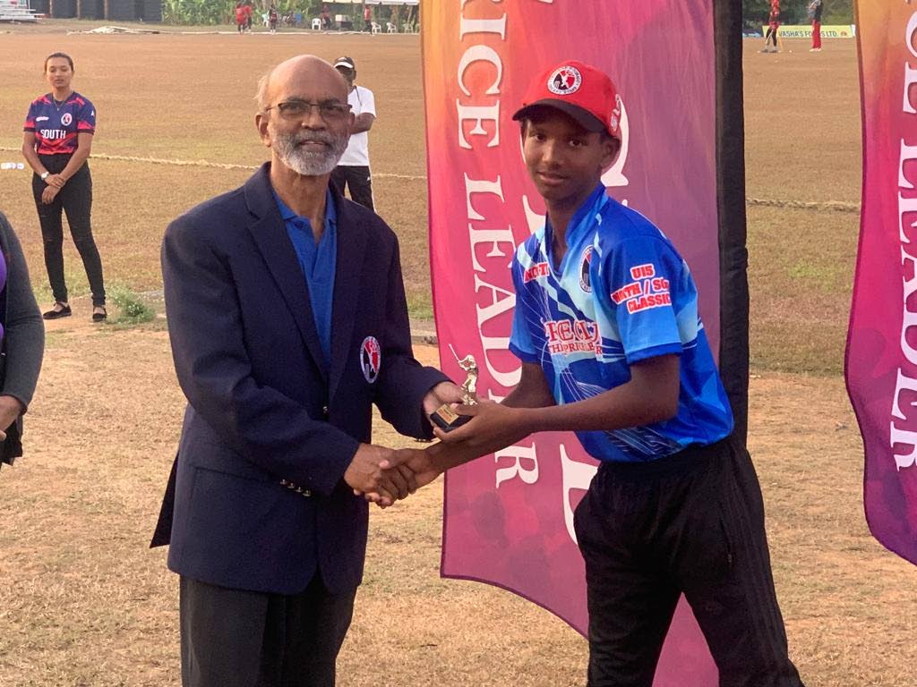 Christian Lall, right, receives the Price Club Supermarket North-South Under-15 Classic man of the match award from Arjoon Ramlal of the TT Cricket Board (TTCB) at the National Cricket Centre in Balmain, Couva on Wednesday  - 