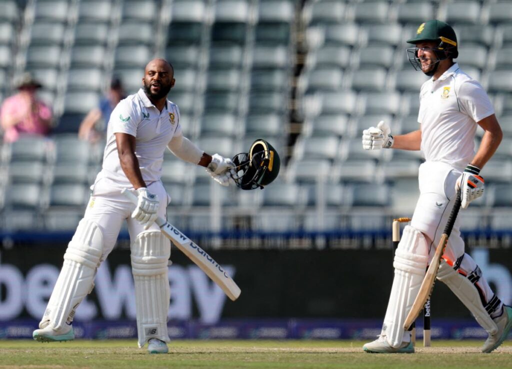 South Africa's captain Temba Bavuma, left, celebrates his century as teammate Wiaan Mulder looks on during the third day of the second Test vs West Indies, at the Wanderers Stadium in Johannesburg, South Africa, Friday. - AP