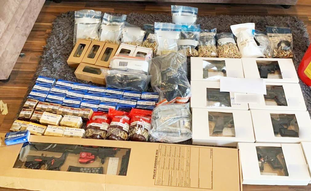 SEIZED: The cache of arms and ammunition seized by police in an apartment unit at the HDC's Victoria Keyes Apartment Tower 2, in Diego Martin on Thursday. PHOTO COURTESY TTPS - 