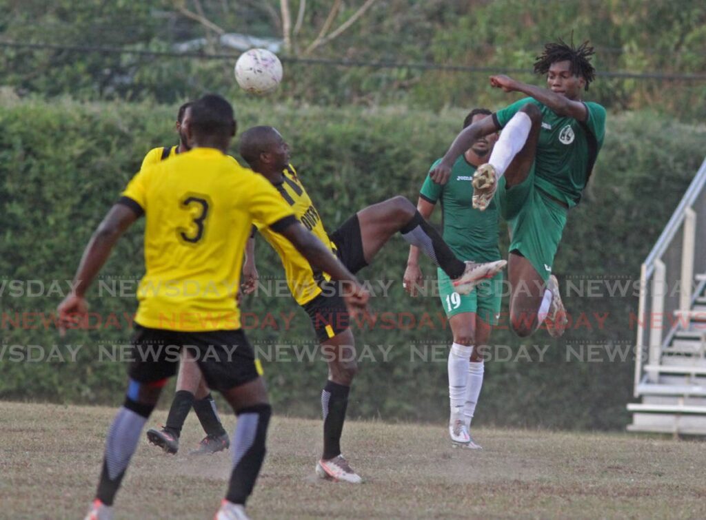 HIGH KICKS: A W Connection player goes airborne in an attempt to win the ball against his Central FC opponent at Mahaica Sports Complex in the Trinidad and Tobago Premier Football league in Point Fortin on Friday. - Marvin Hamilton