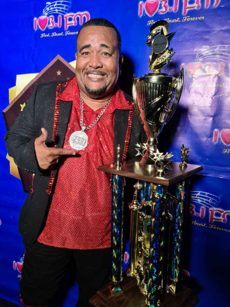 Daddy Chinee (Ricardo Melville) with his trophy after winning the 103.1 FM Chutney Soca Road March on Friday night.  - Photo courtesy 103.1 FM