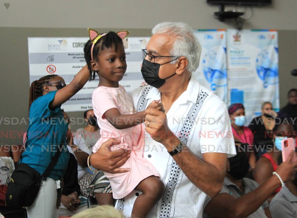 Health Minister Terrance Deyalsingh enjoys a dance with little Joanna Maitland during the ministry's national screening weekend at the Eric Williams Medical Sciences Complex on Sunday. Photo by Ayanna Kinsale