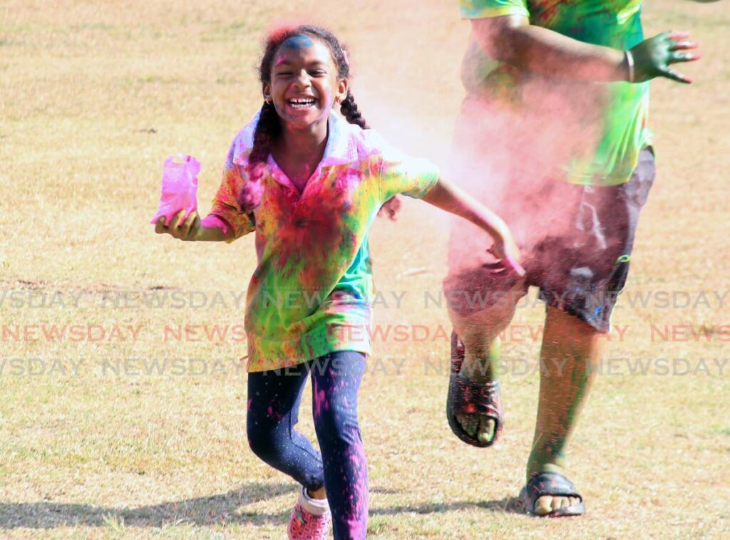 Zhuri Blake, 5, enjoys herself during Phagwa celebrations at the El Dorado Recreation Grounds on Sunday. - AYANNA KINSALE