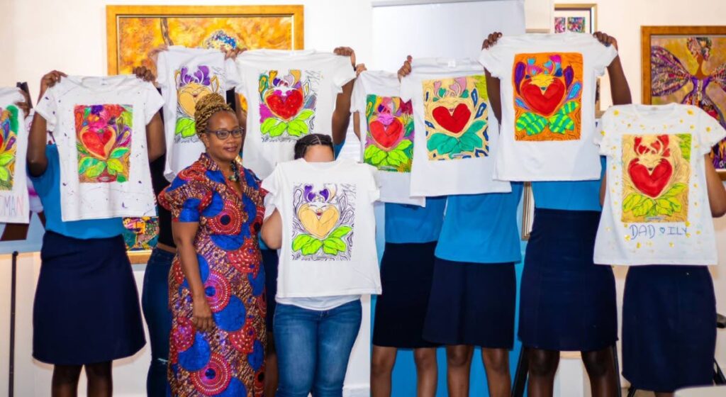 Creative director of Chosen Hands Anika Plowden-Corentin and students of the St Jude's Home for Girls proudly display their works of art at Inspired and Paint, an International Women's Day workshop which was facilitated by Republic Bank under its Power to Make A Difference Programme.   - Courtesy Damian Luk Pat