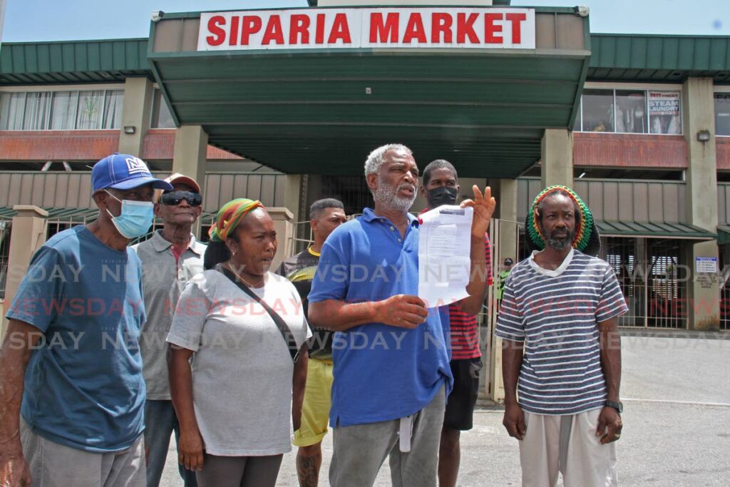 Siparia Market vendors speak to media outside the premises on Monday. - Marvin Hamilton