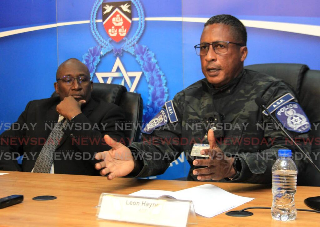 ASP Leon Haynes, right, speaks as DCP Curt Simon looks on during a media conference at the Police Administration Building on Sackville Street, Port of Spain, on Thursday. Photo by Ayanna Kinsale