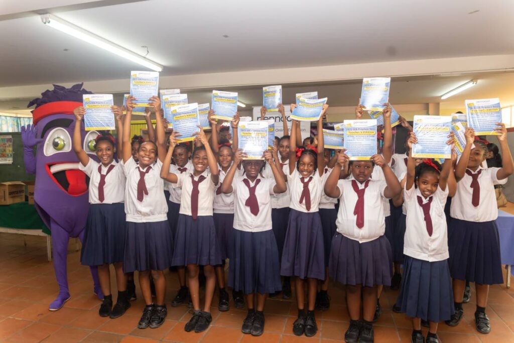 FROM SMALTA, WITH LOVE: SEA students from Marabella Girls AC Primary School gleefully show their Pennacool.com SEA practice kits donated by Carib Brewery through its Smalta, non-alcoholic malt beverage brand. PHOTO COURTESY CARIB BREWERY - 