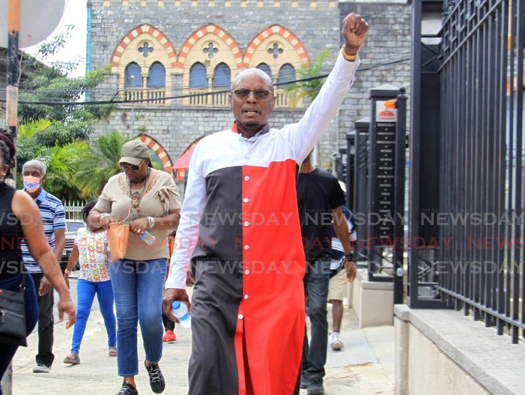 Activist Wendell Eversley makes his way around the Red House on Hart Street, Port of Spain during a march against human trafficking on Friday. - AYANNA KINSALE